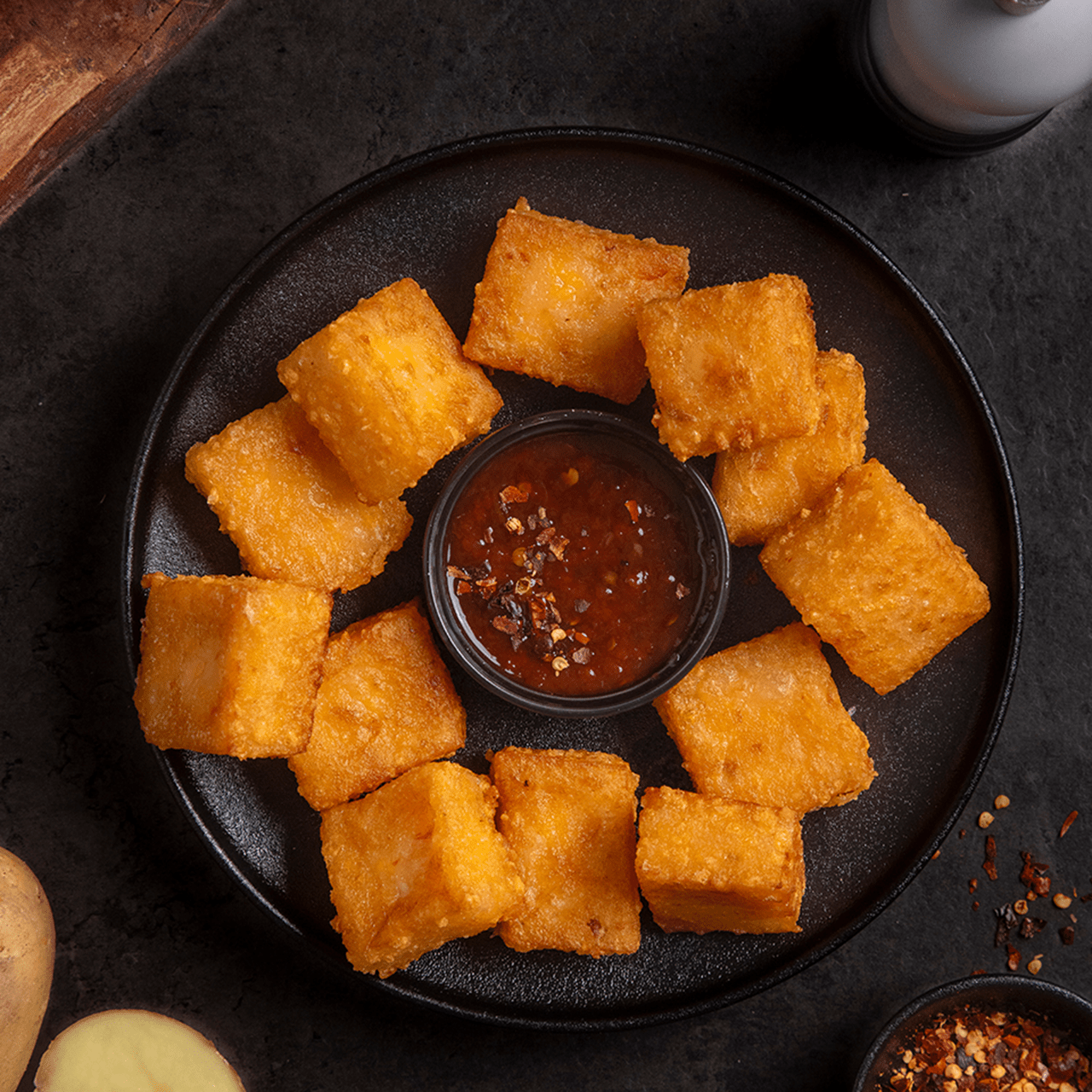 Close‑up of crispy, golden potato puffs made with tapioca starch and Violife dairy free cheese shreds.