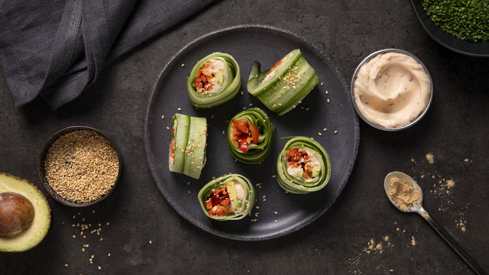 Cucumber sushi rolls made from thin cucumber strips wrapped around  smoked salmon, carrot sticks, red pepper, avocado and dairy free cream cheese.