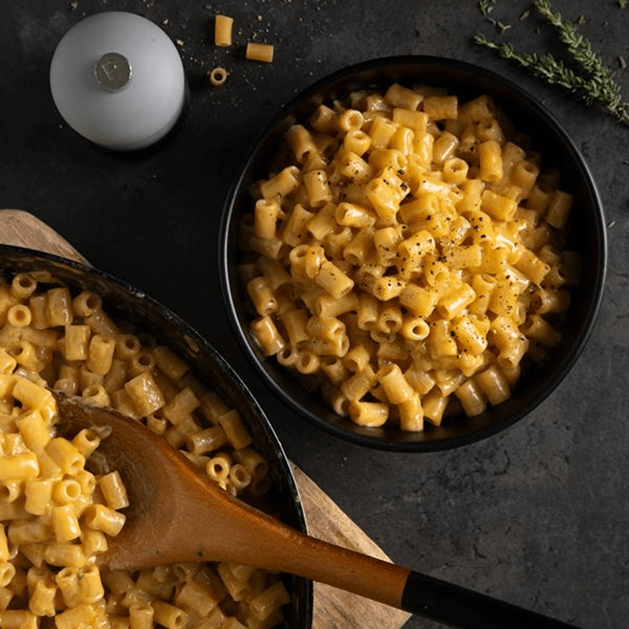 A bowl of creamy French onion pasta made with ditalini, white wine and Worcestershire sauce,  topped with extra black pepper and dairy free cheese.