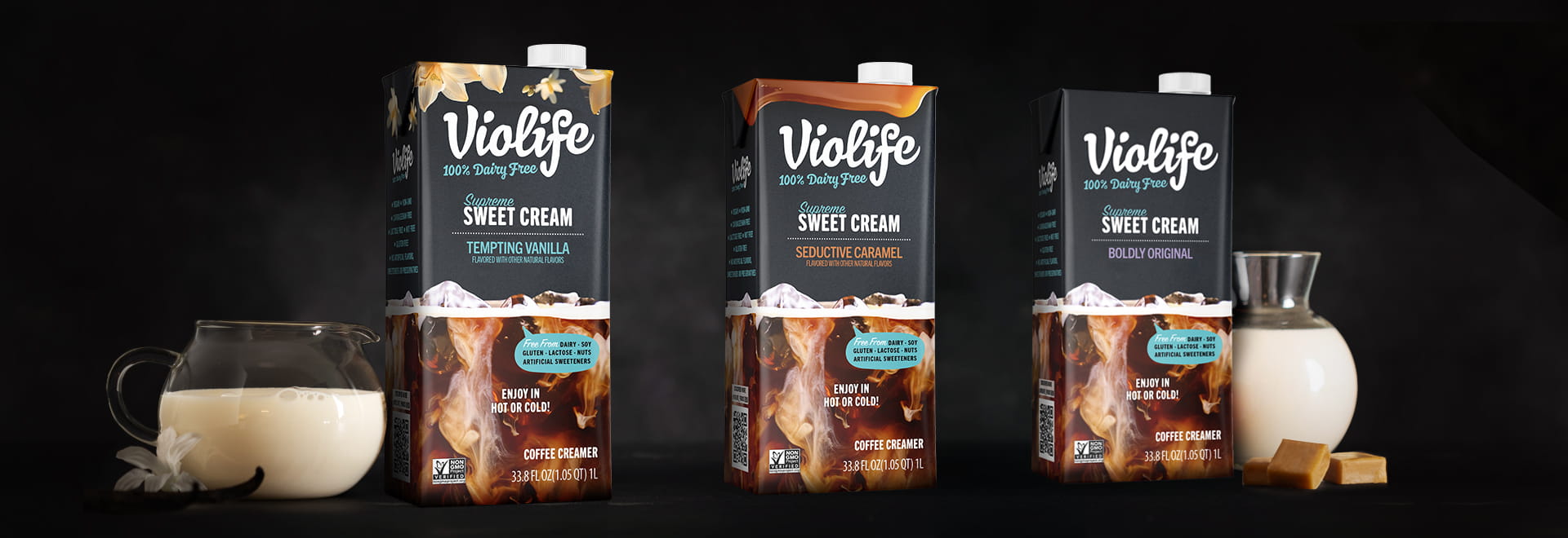 Cartons of Violife Supreme Sweet Cream coffee creamer - Tempting Vanilla, Seductive Caramel and Boldly Original, displayed against a dark background.